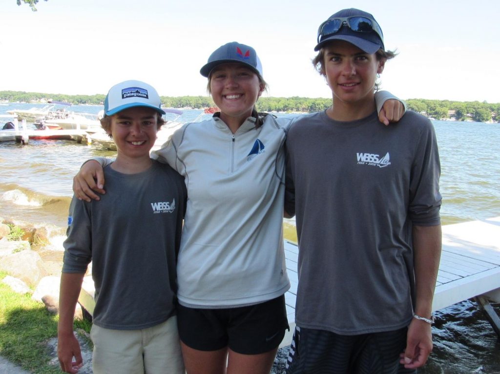 Past ILYA X Senior Fleet Champion and WBSS Coach Kate Cox poses with Hank (left) and Owen (right) after the regatta.